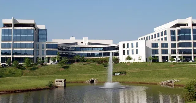 A large building with a fountain in front of it