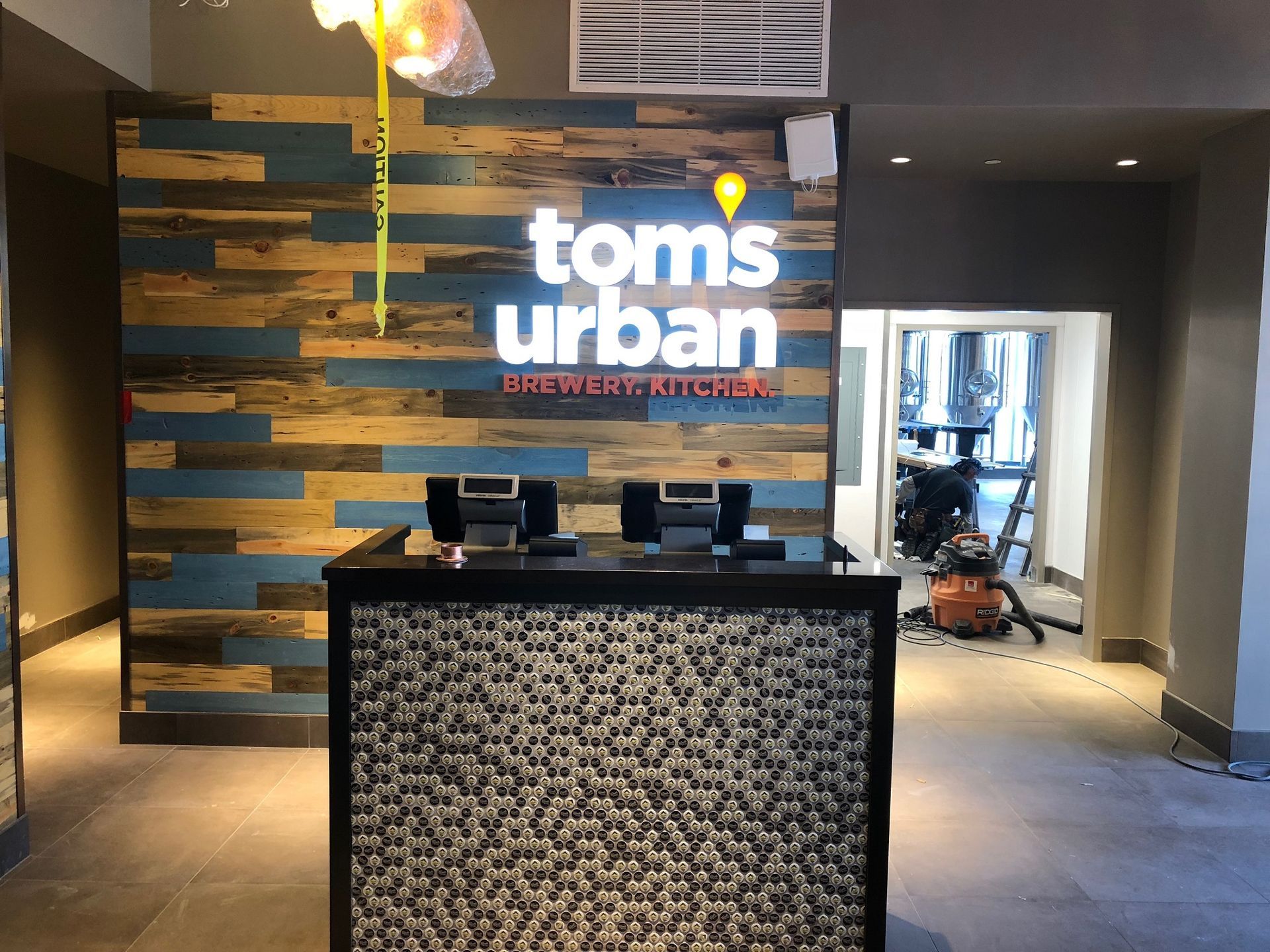 A tom 's urban restaurant with a wooden wall