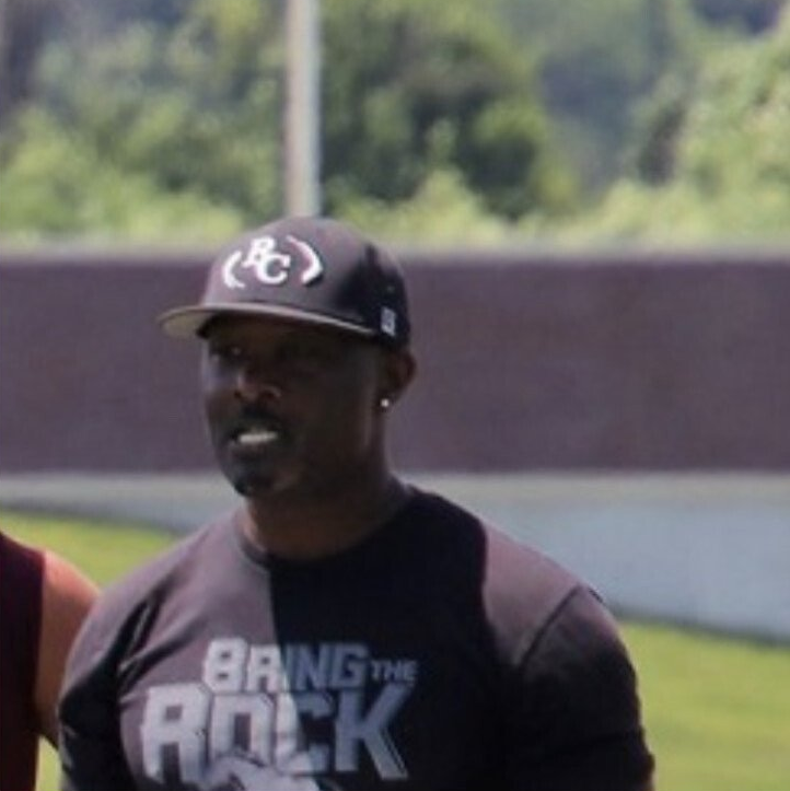 A man wearing a black shirt that says bring the rock