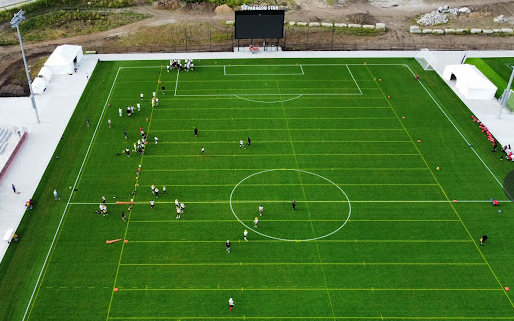 An aerial view of a soccer field with people playing on it.
