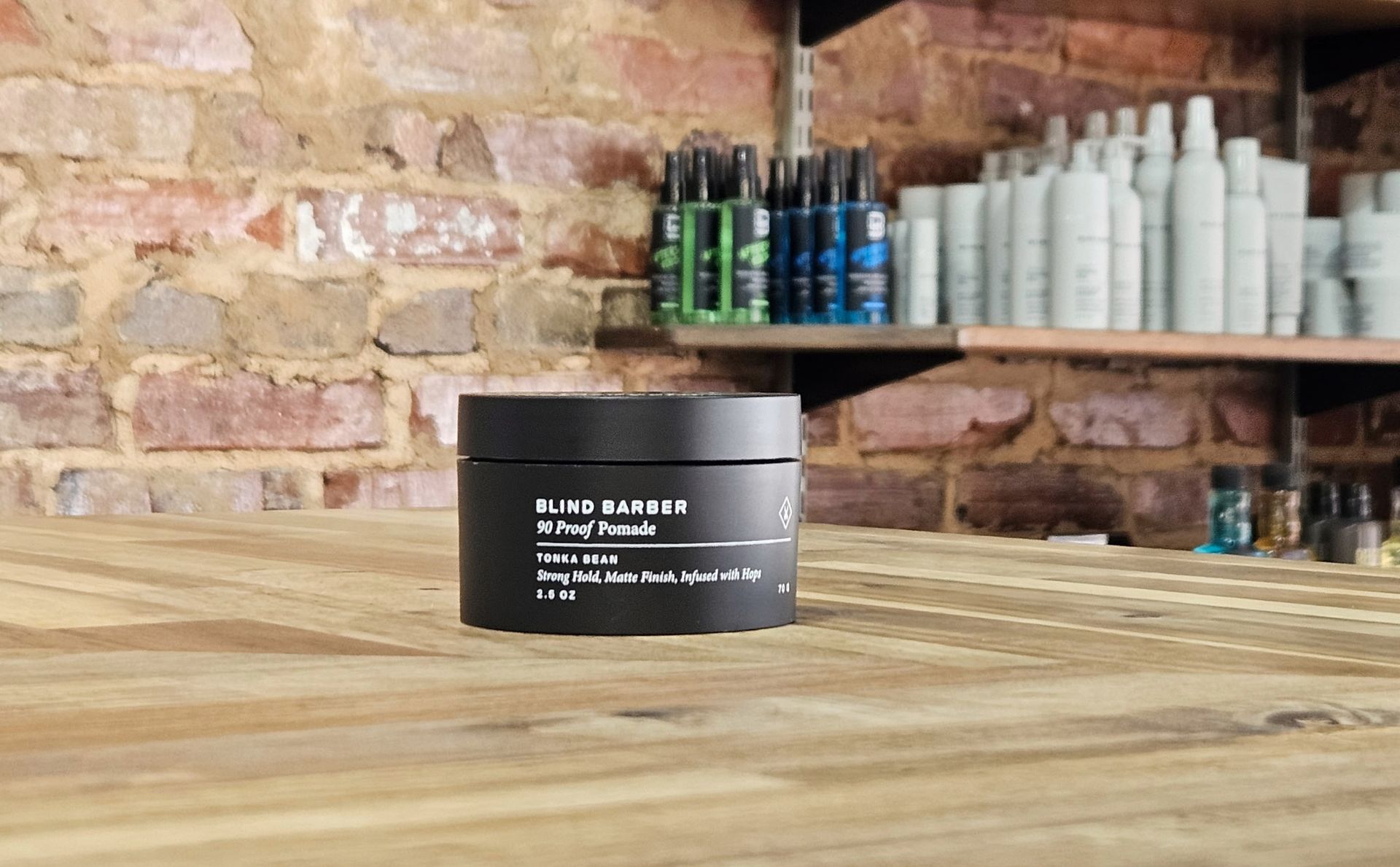 Bottles of Reuzel aftershave and grooming products in various colors displayed on a shelf.