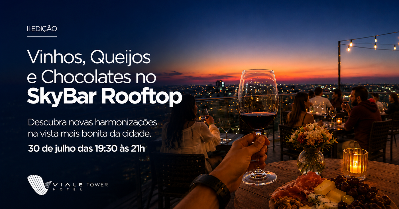 Jantar ao pôr do sol no terraço com vinho espumante e chocolates, com vista para o horizonte da cidade.