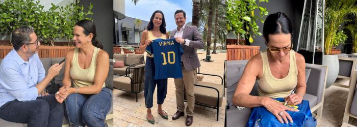 Woman holds a blue jersey with 