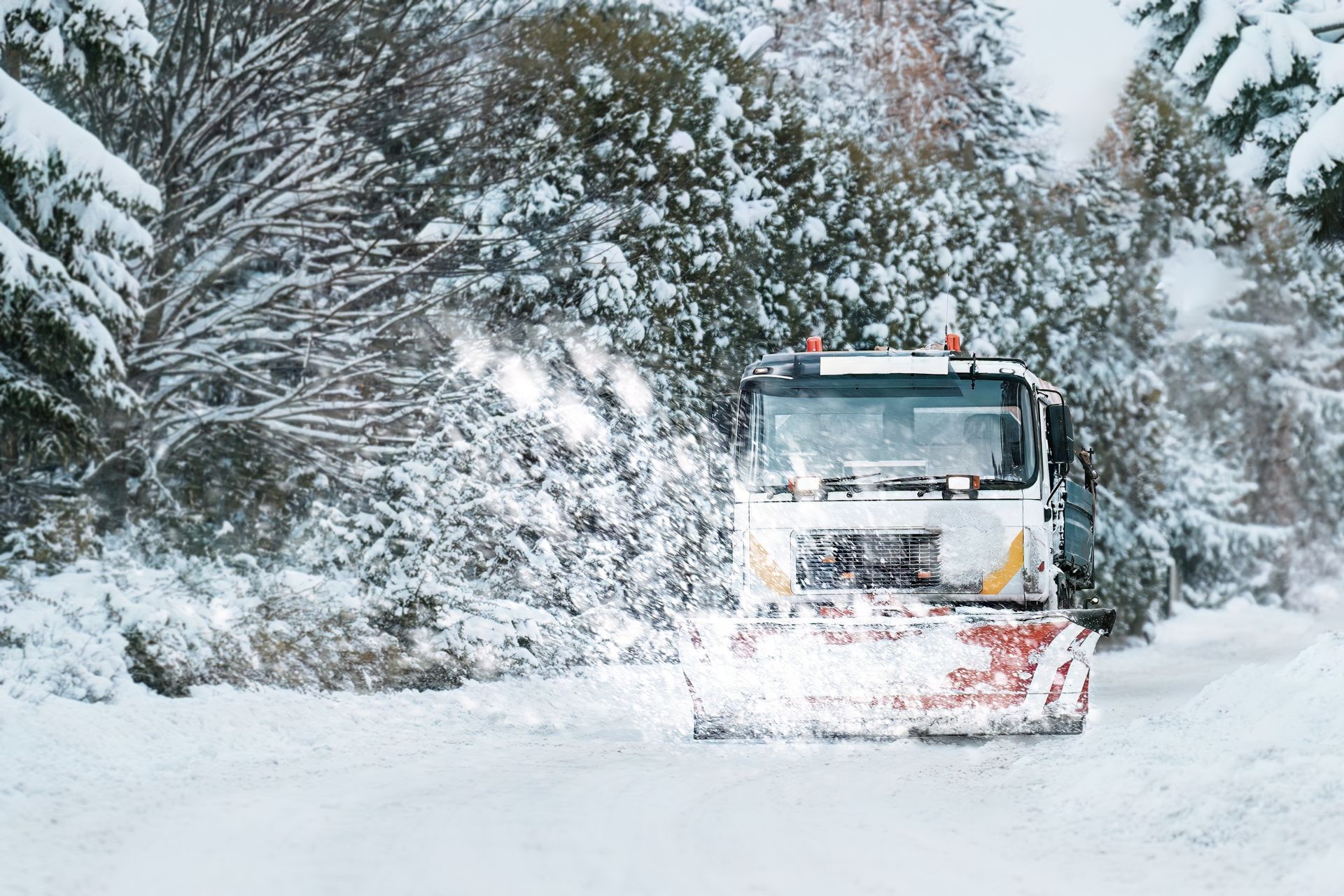 Truck removing snow in road