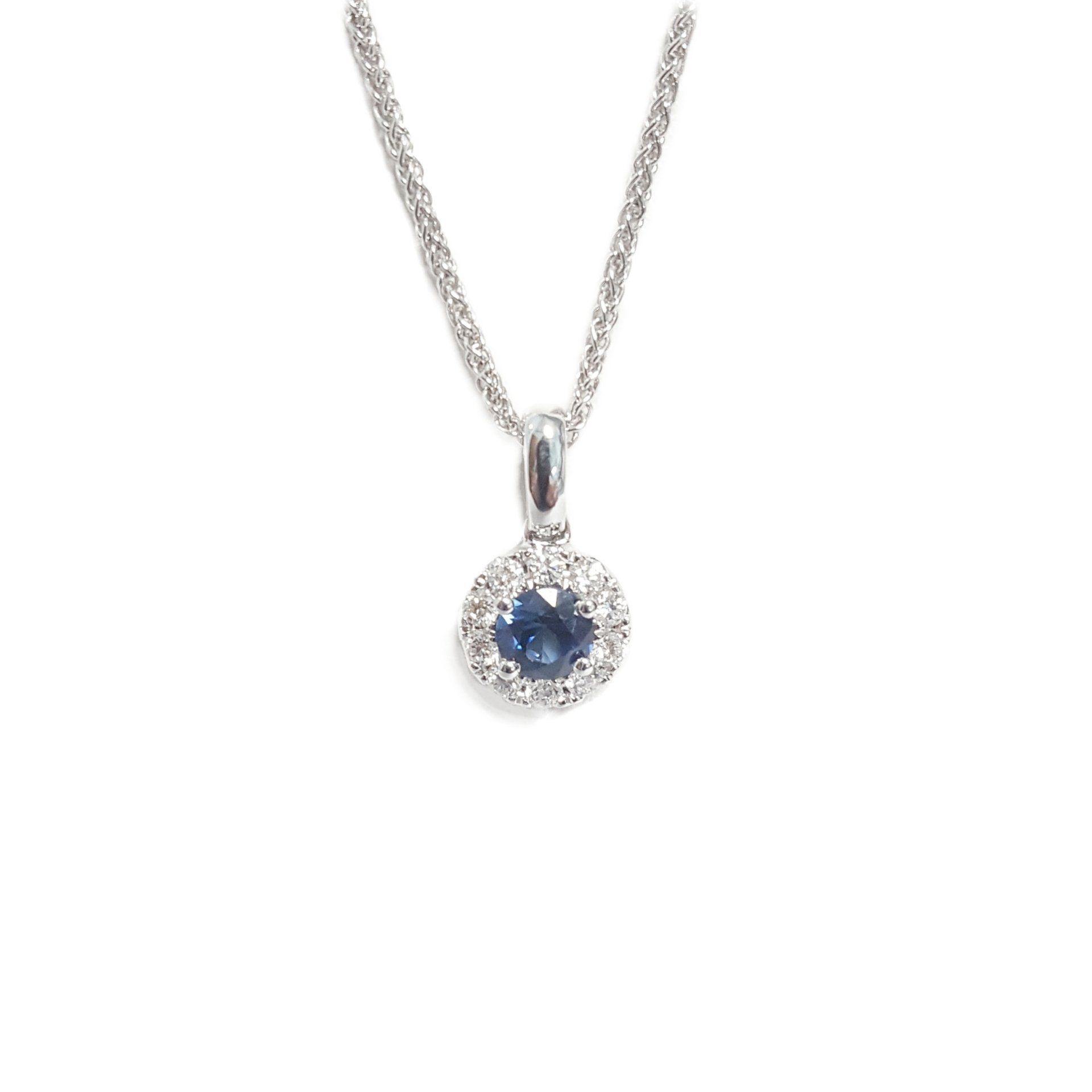 A necklace with a sapphire and diamonds on a chain