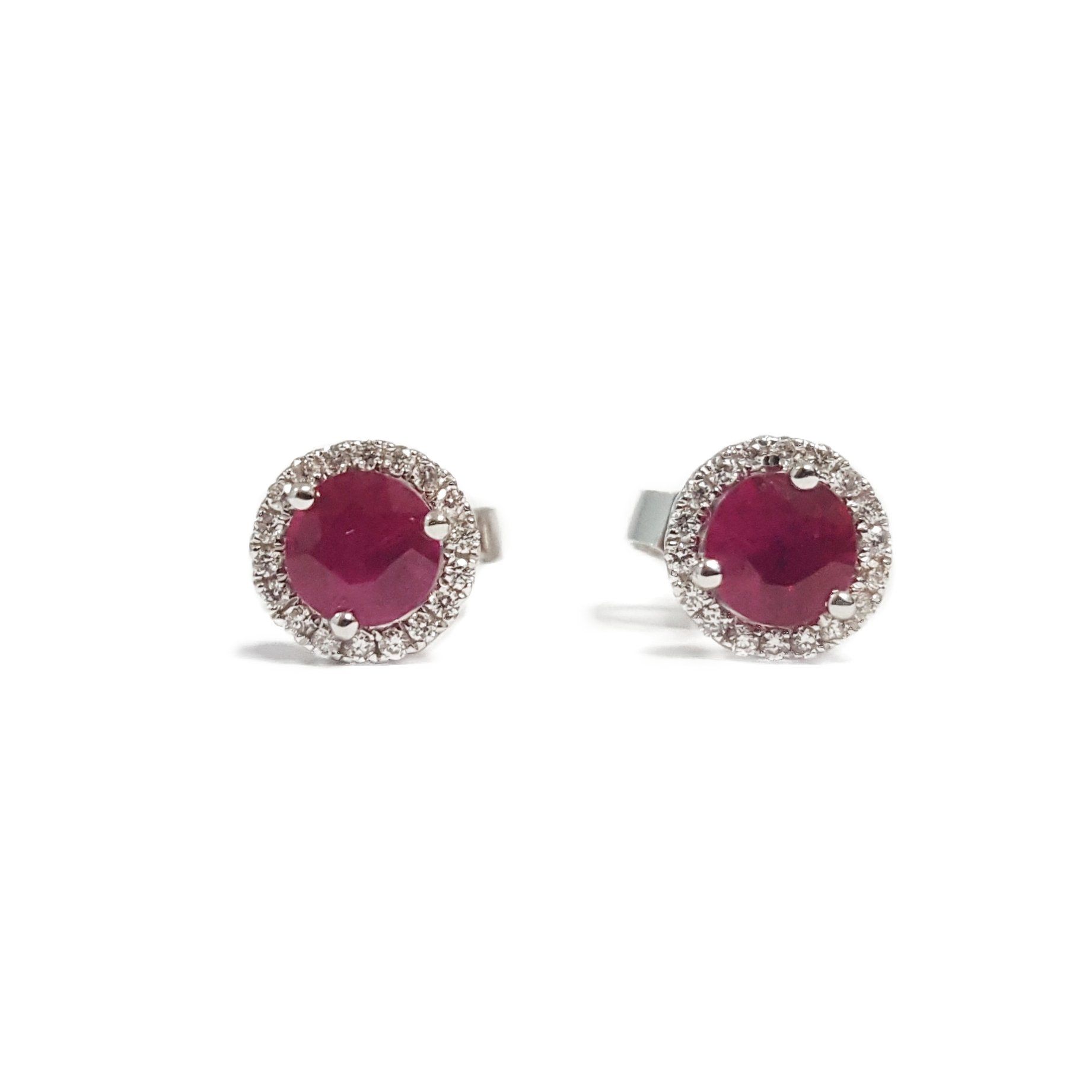 A pair of stud earrings with a ruby and diamonds