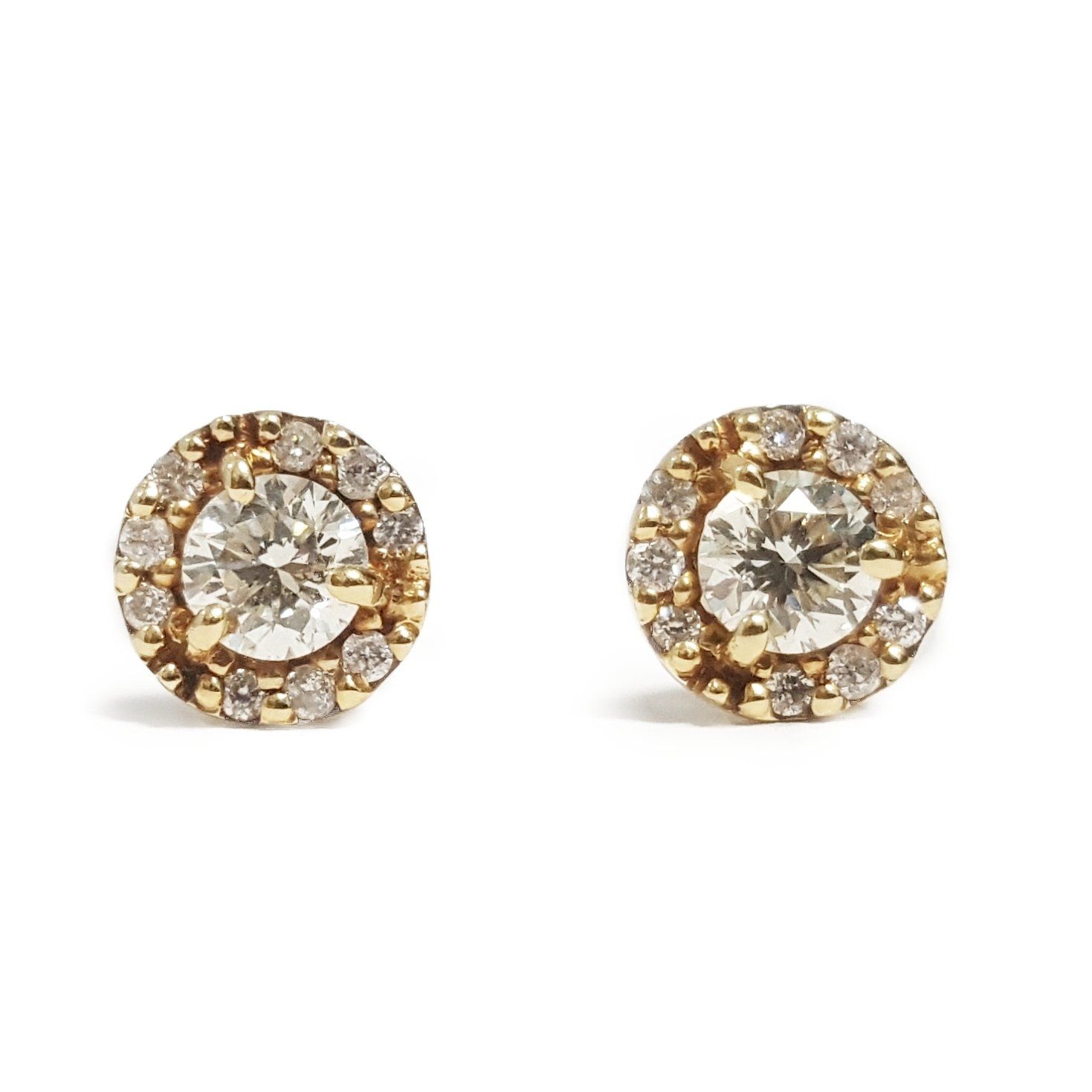 A pair of gold stud earrings with a diamond in the center