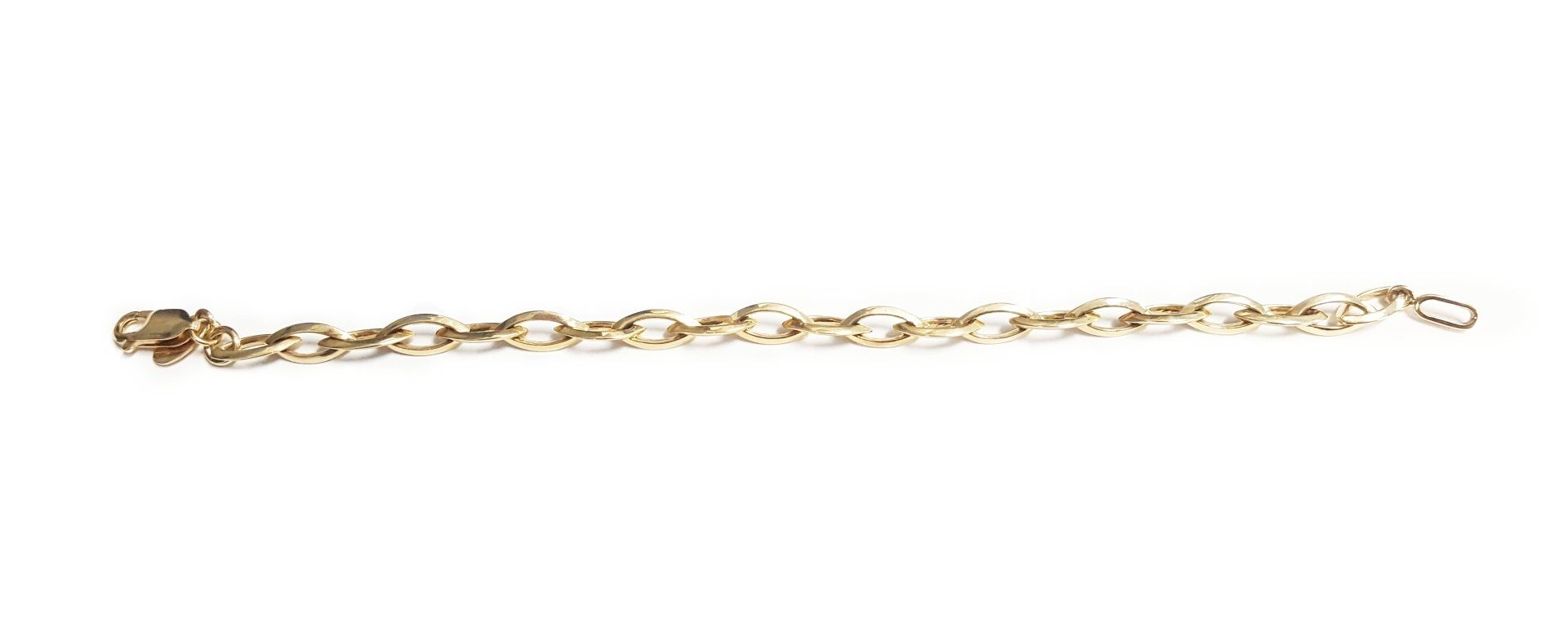 A close up of a gold chain on a white background.