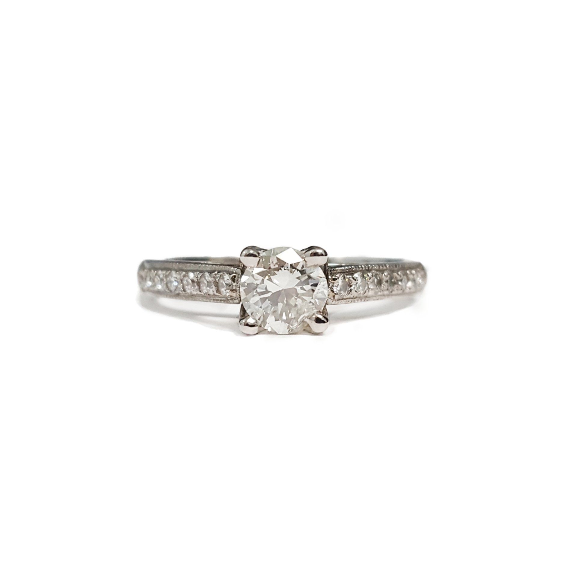 A white gold ring with a diamond in the center on a white background.