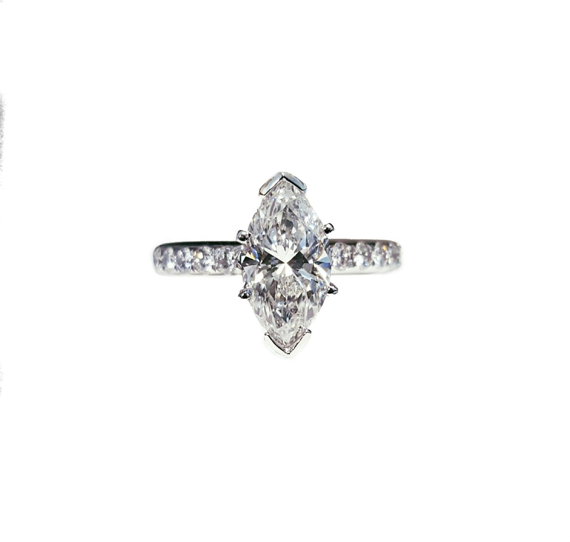 A diamond ring with a marquise cut diamond on a white background.