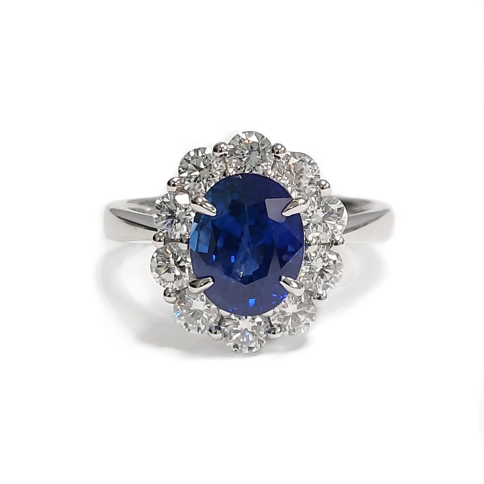 A white gold ring with a sapphire and diamonds