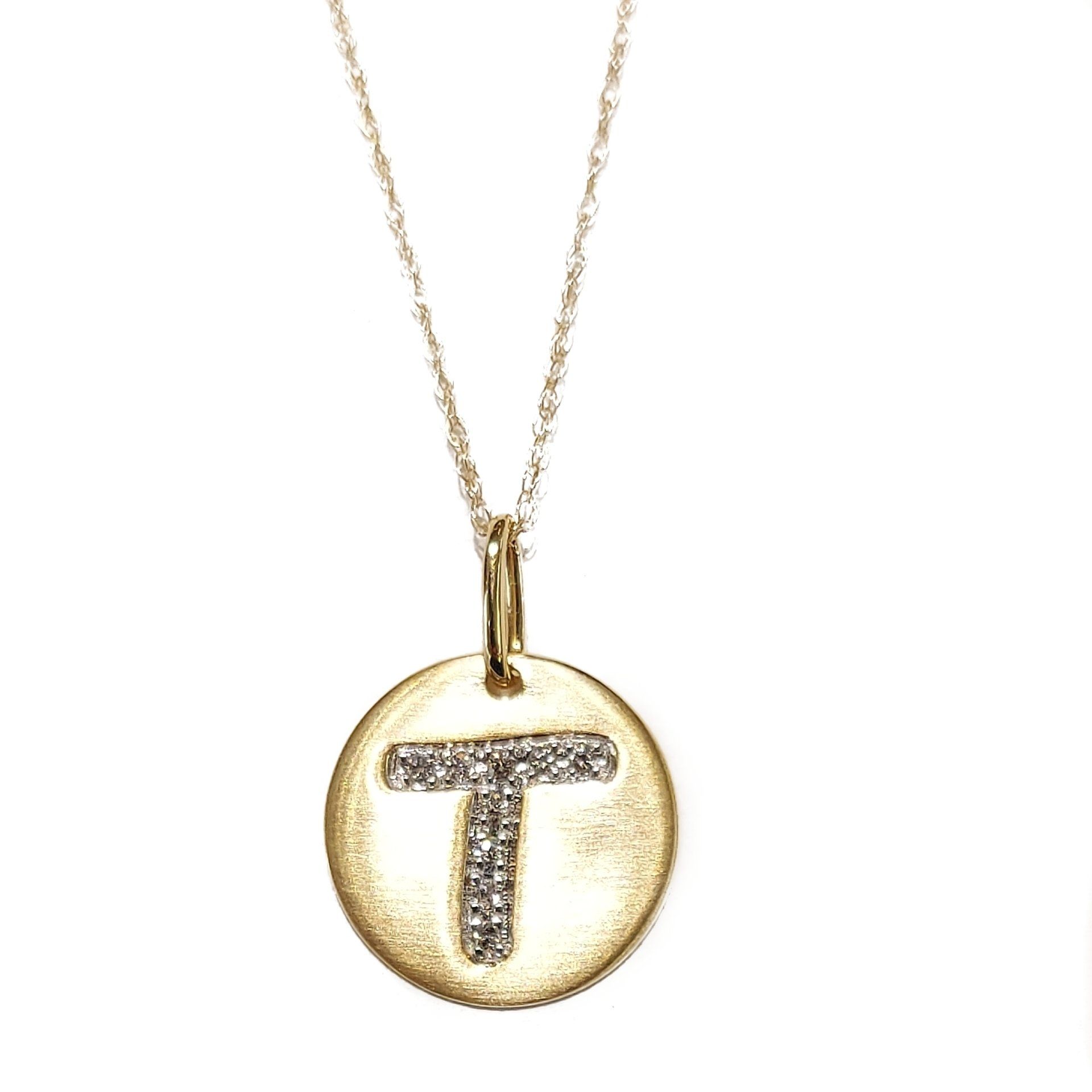 A gold necklace with the letter t on it