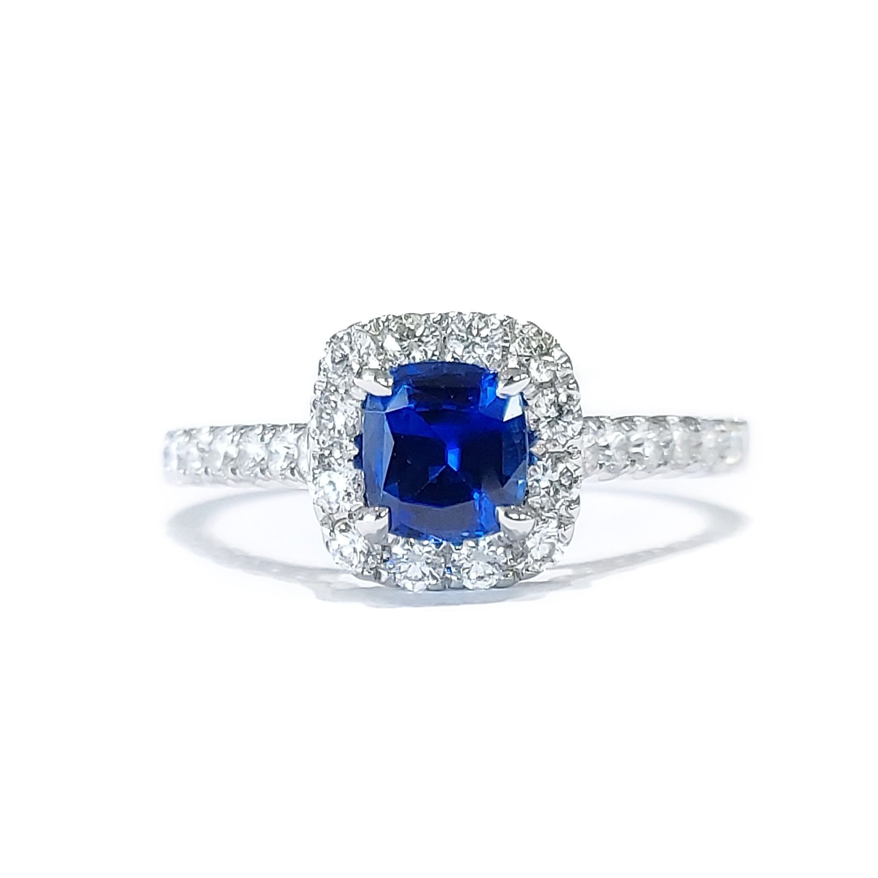 A sapphire and diamond ring in white gold on a white background.