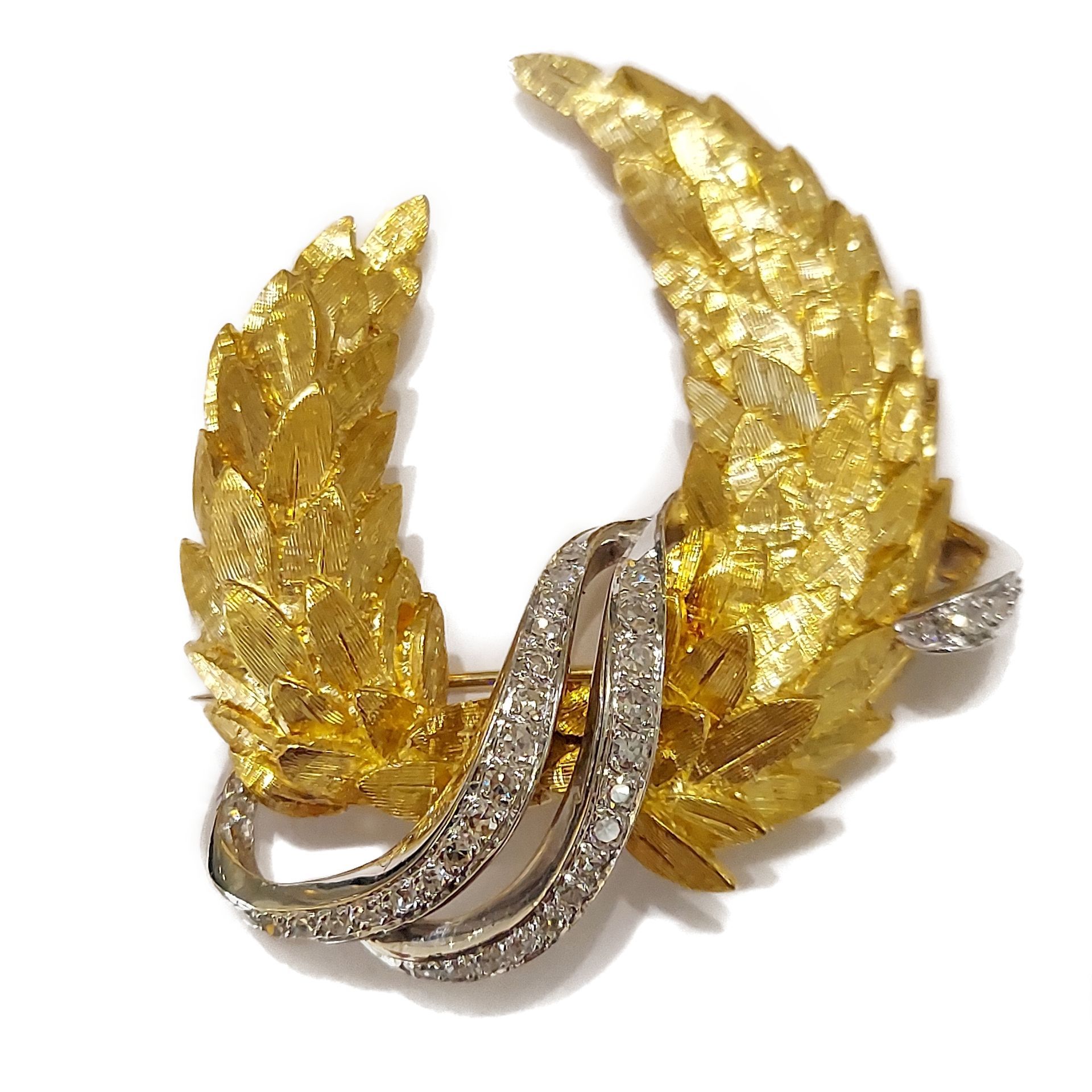 A brooch in the shape of a laurel wreath with diamonds