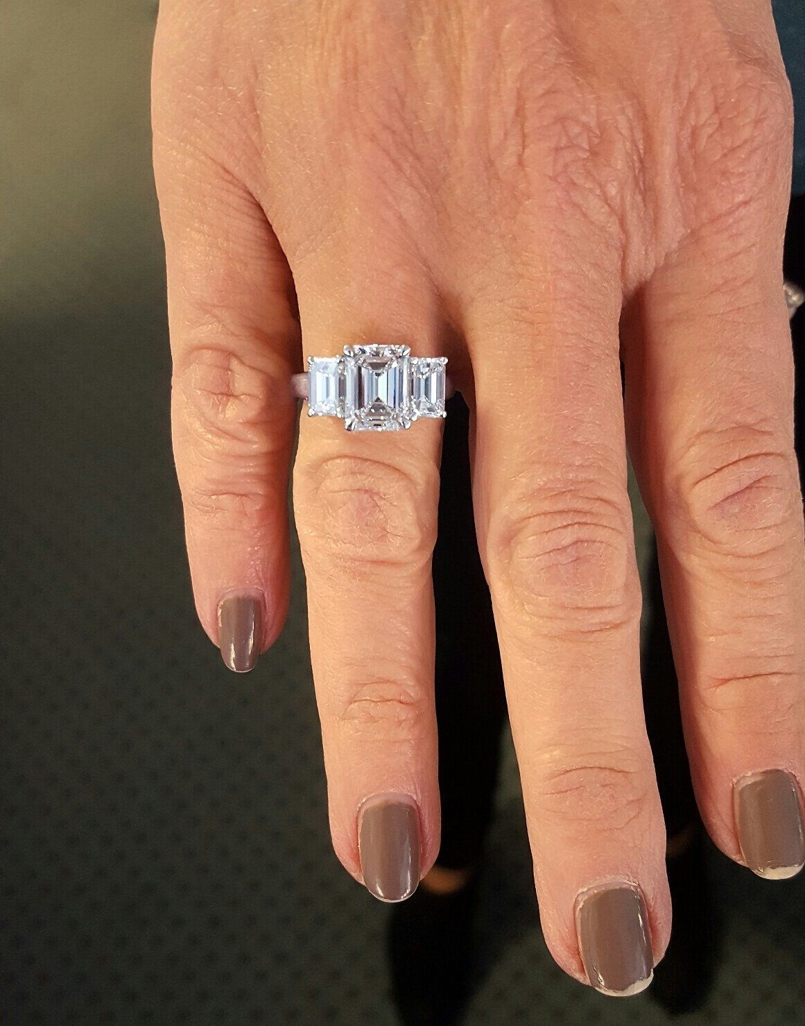 A close up of a woman 's hand with a ring on her finger