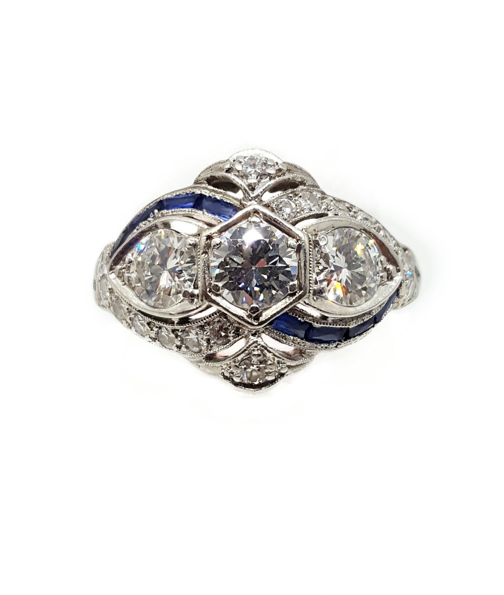 A white gold ring with diamonds and blue enamel on a white background.