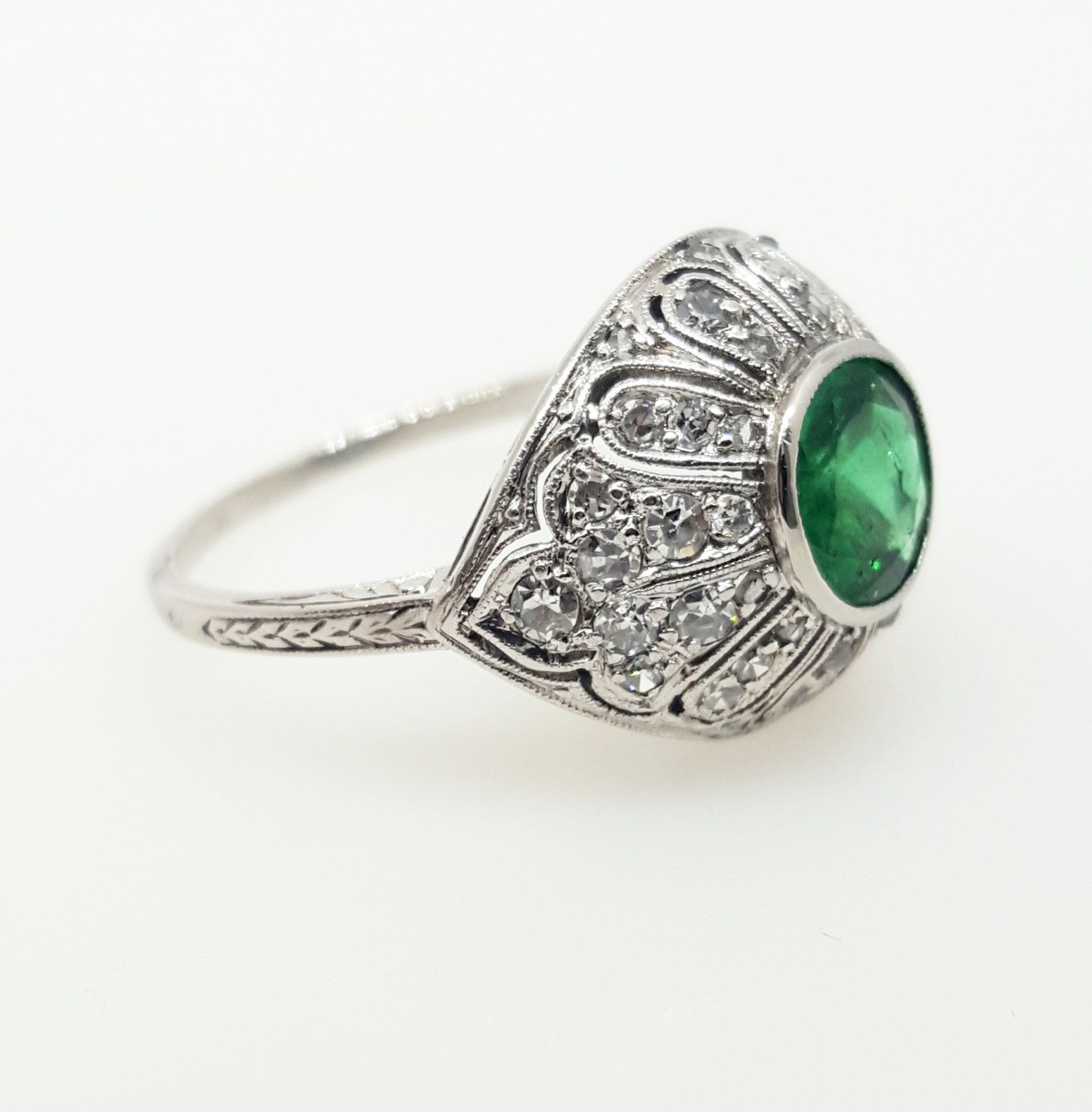 A silver ring with a green stone in the center