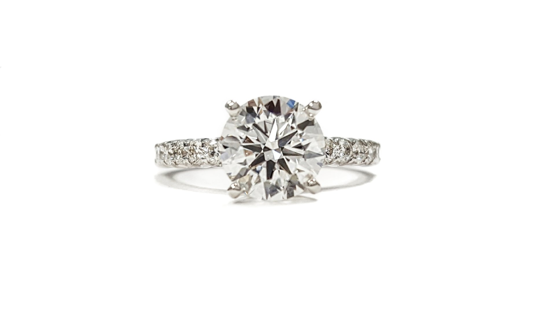 A diamond ring with a large diamond in the center on a white background.