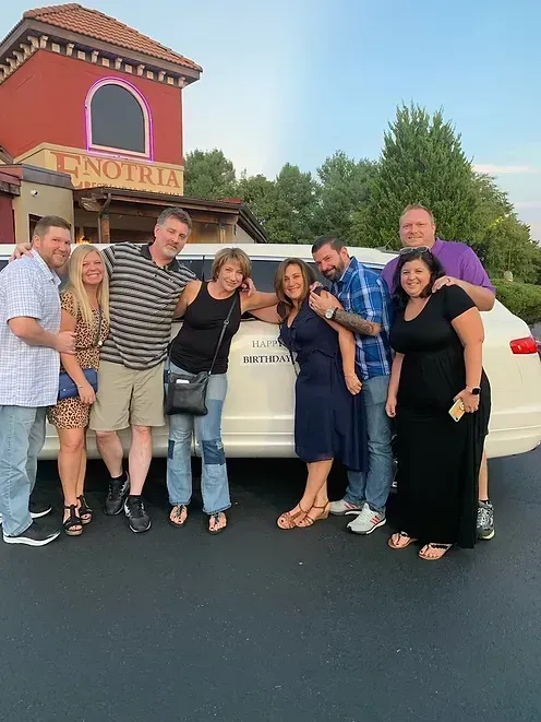 Group of eight people pose outside 