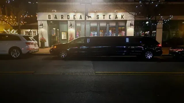 A black limousine parked in front of 