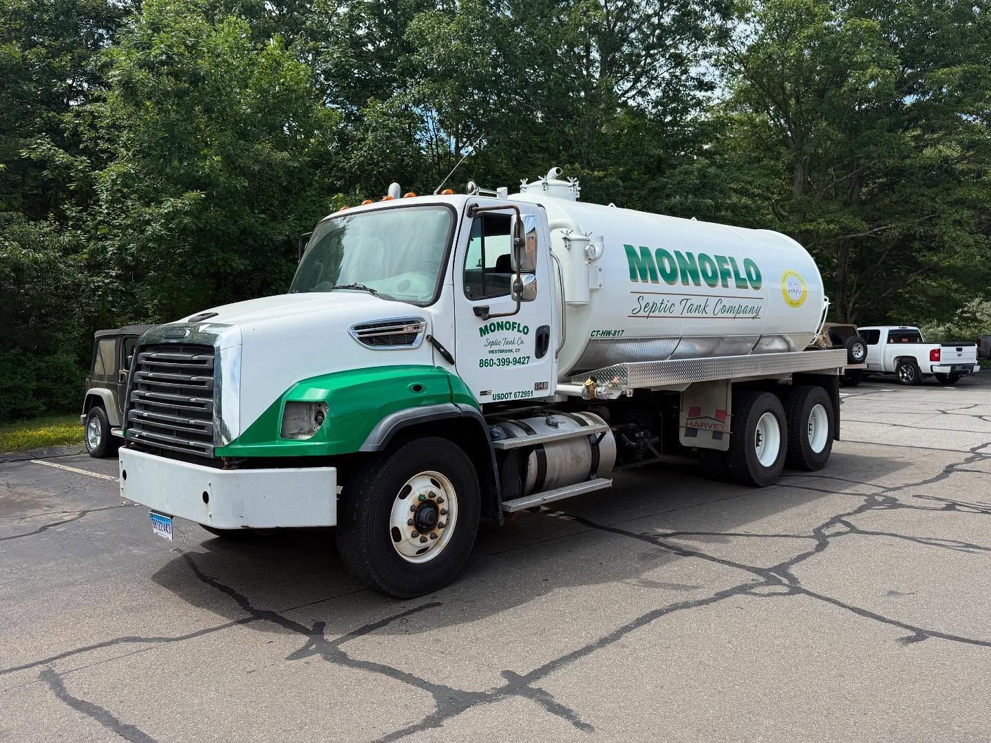 White and green Monoflo fuel truck on a paved surface.