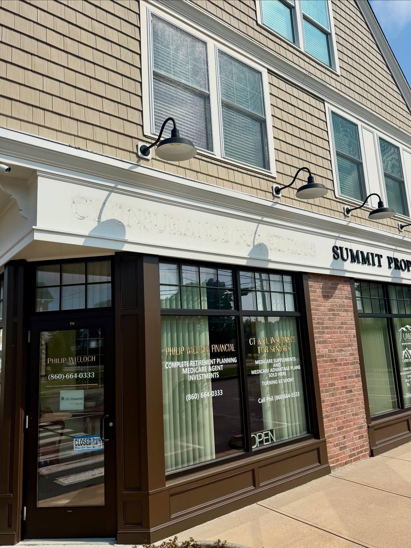Brown and beige building with large windows, signage