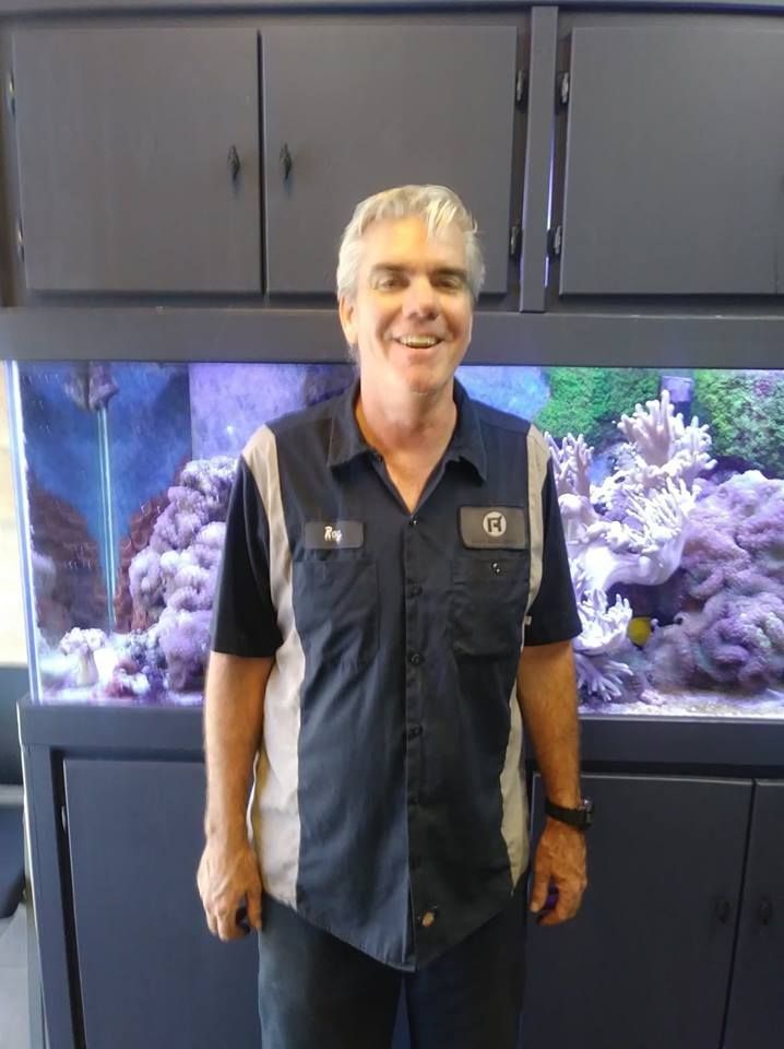 Auto Technician Smiling Inside Repair Shop Office | Roy's Auto Service