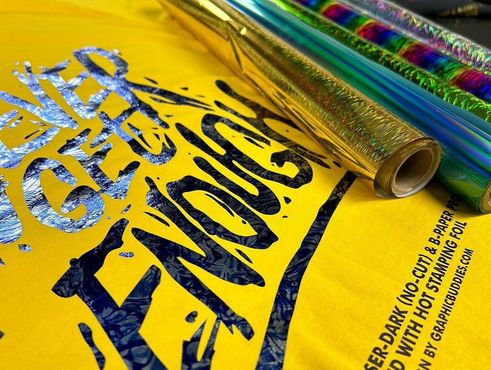 Yellow shirt with metallic foil print and rolls of foil.