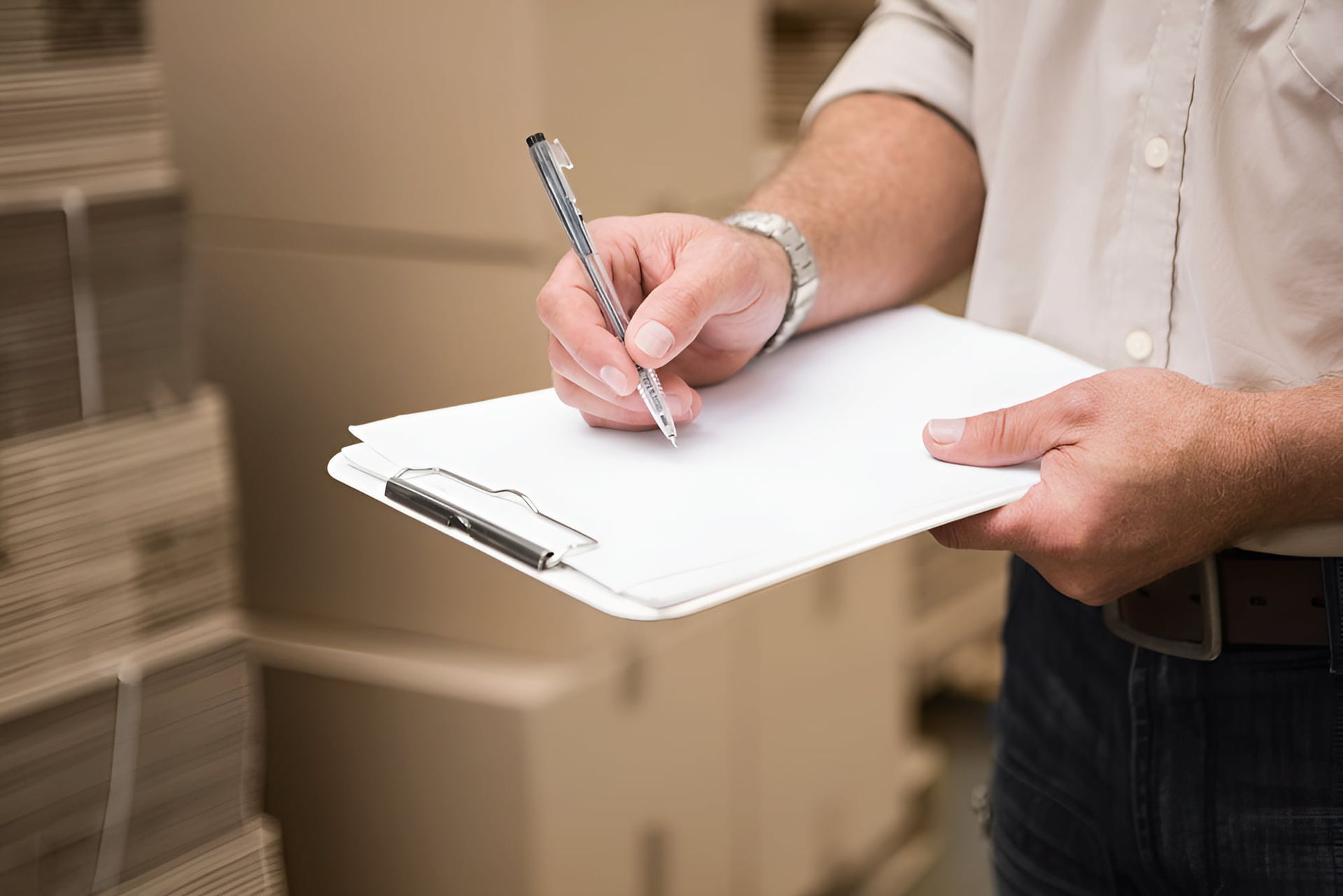 Writing on a clean white paper with clipboard