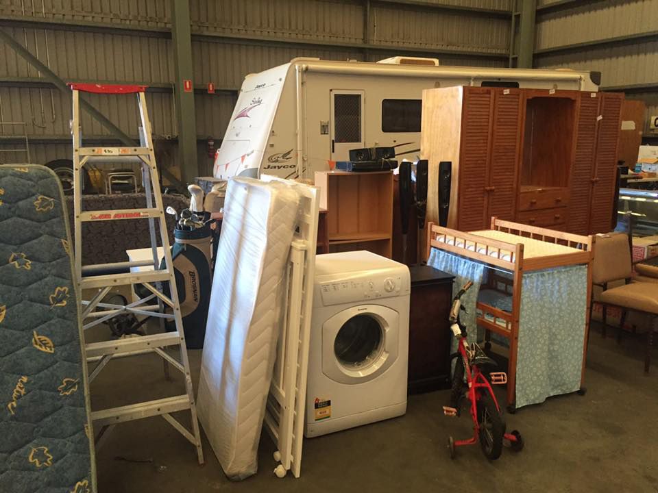 A Warehouse Filled With Lots Of Furniture And Appliances — Dawson Moving & Storage NQ in Mount St John, QLD