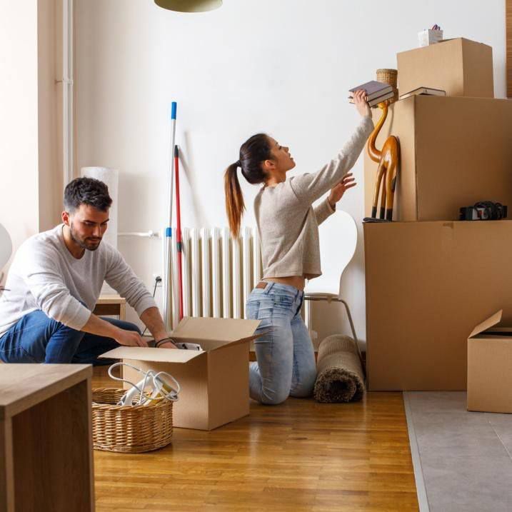Couple Unpacking Things After Moving Into New House — Dawson Moving & Storage NQ in Brisbane, QLD