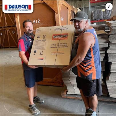 Two Men Are Carrying A Large Cardboard Box In A Warehouse — Dawson Moving & Storage NQ in Mount St John, QLD