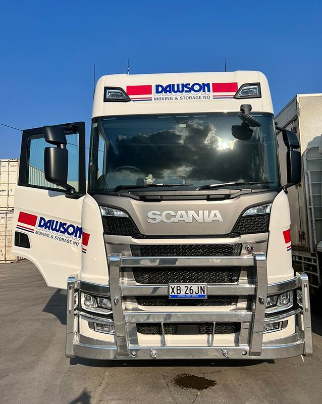 A White Scania Truck Is Parked In A Parking Lot With Its Doors Open — Dawson Moving & Storage NQ in Mount St John, QLD