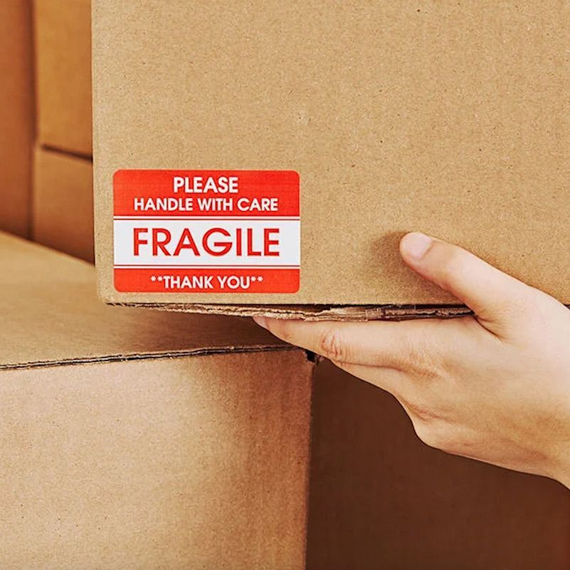 Hand Truck With Cardboard Boxes On Brick Wall Background — Dawson Moving & Storage NQ in Brisbane, QLD