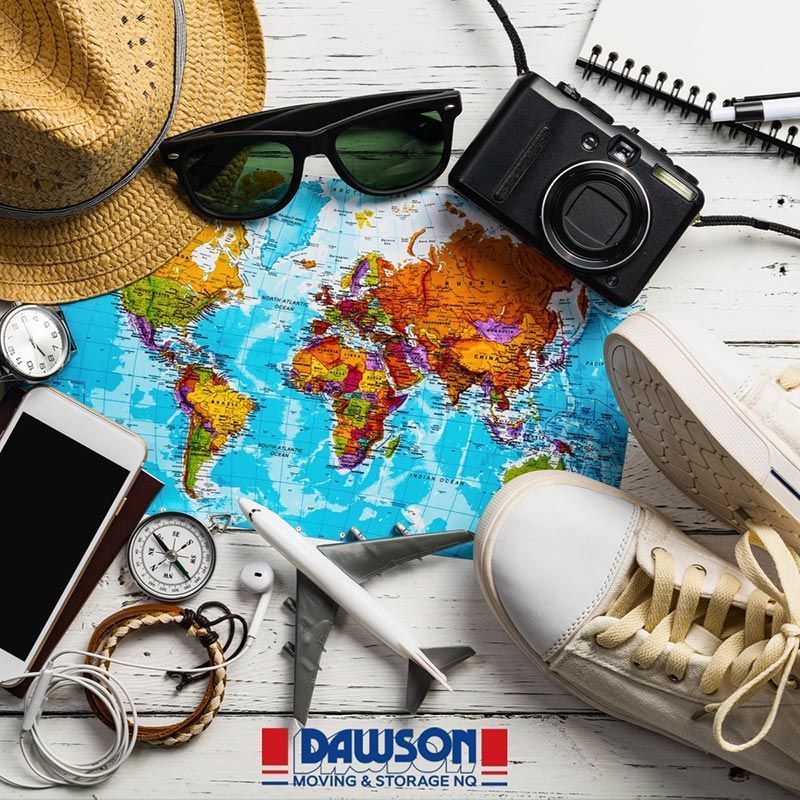 A Map Of The World Is Surrounded By A Hat, Sunglasses, A Camera, And A Pair Of Shoes — Dawson Moving & Storage NQ in Mount St John, QLD