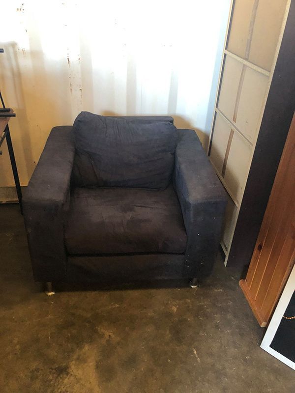 A Black Chair Is Sitting On A Concrete Floor In A Room  — Dawson Moving & Storage NQ in Canberra, ACT