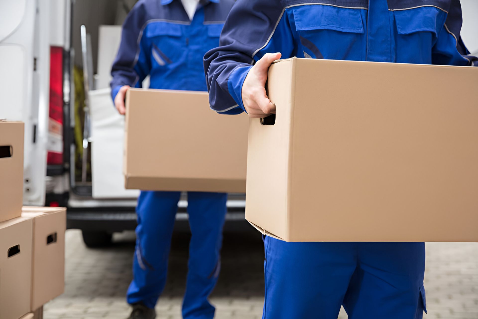 Two Men Carrying Cardboard Boxes — Dawson Moving & Storage NQ In Mount St John, QLD