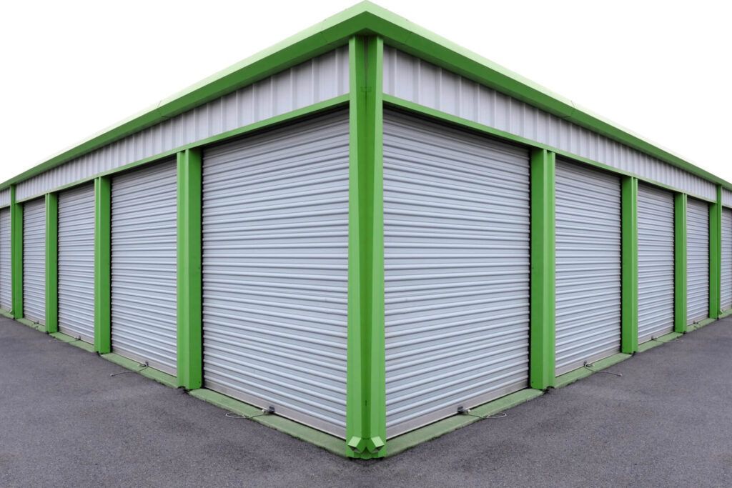 A Row of Storage Units with Green and White Doors — Dawson Moving & Storage NQ in Mount St John, QLD