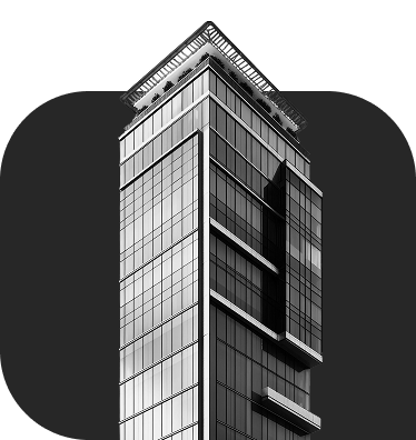 High-rise glass skyscraper in black and white with a modern, triangular roof.
