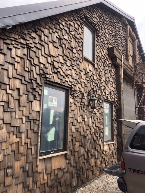 A toyota truck is parked in front of a wooden building