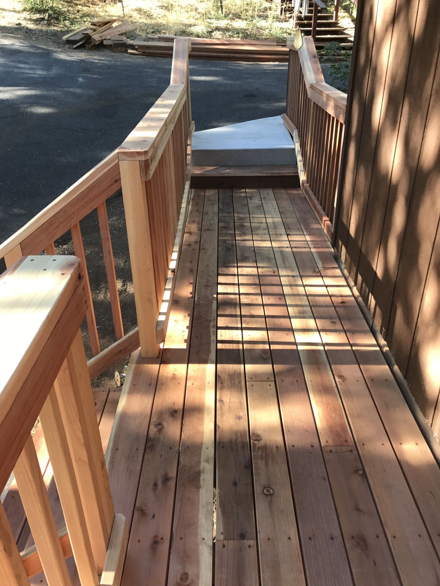 A wooden deck with stairs leading up to it