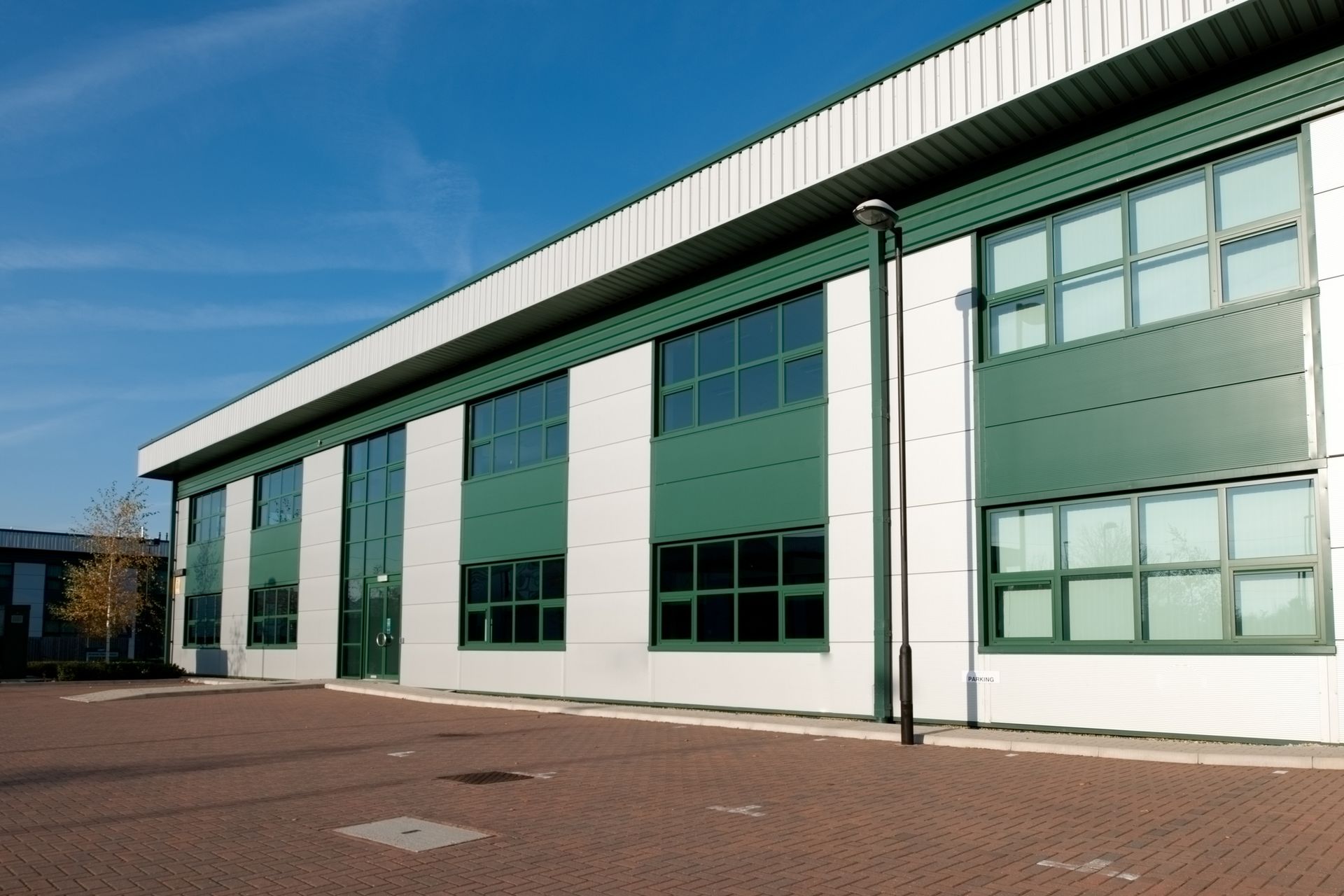 A large white and green building with a lot of windows