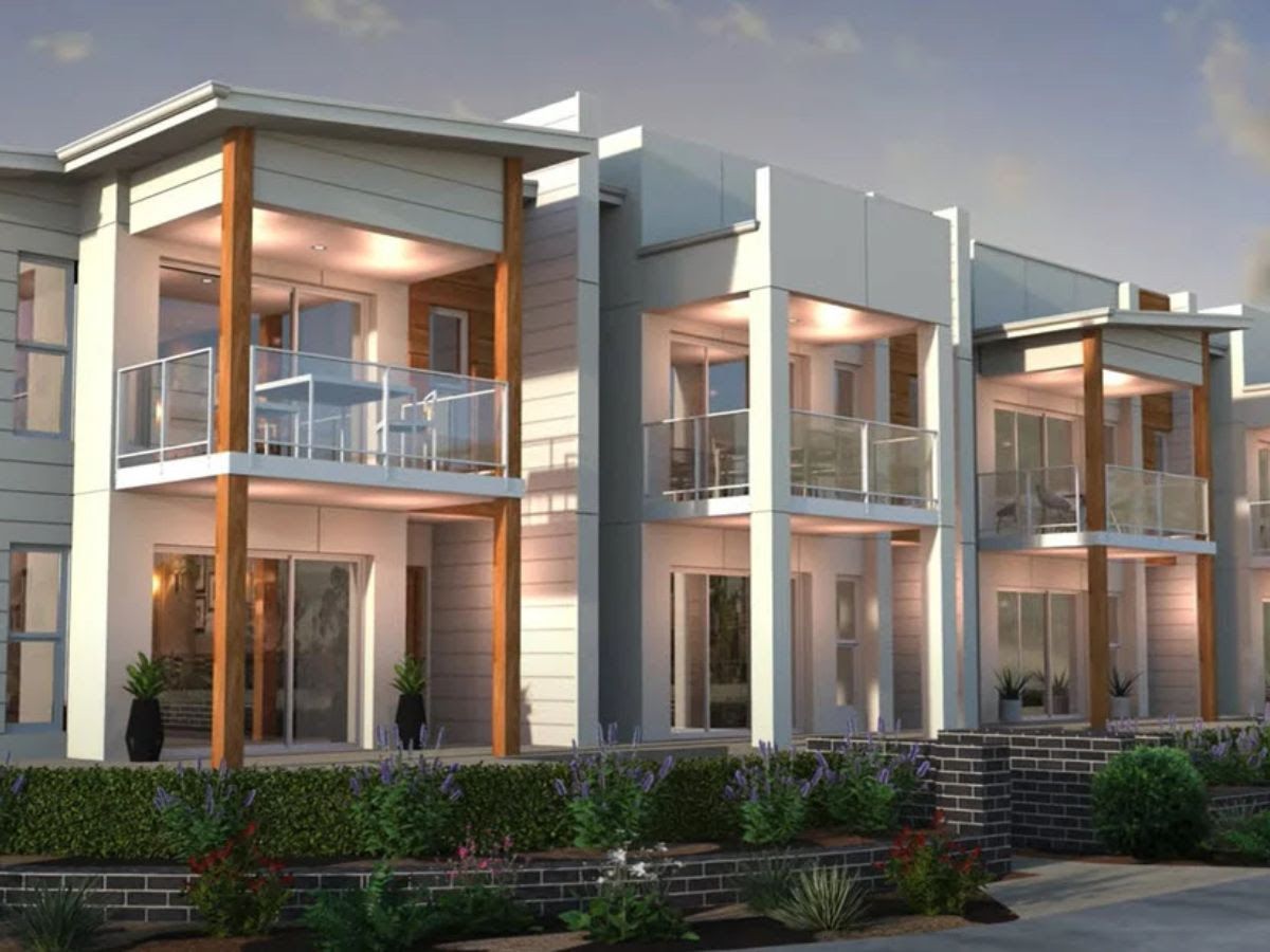 Modern townhouses with balconies, neutral tones, and landscaping.