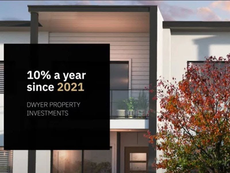 Black square with white text over a modern house: