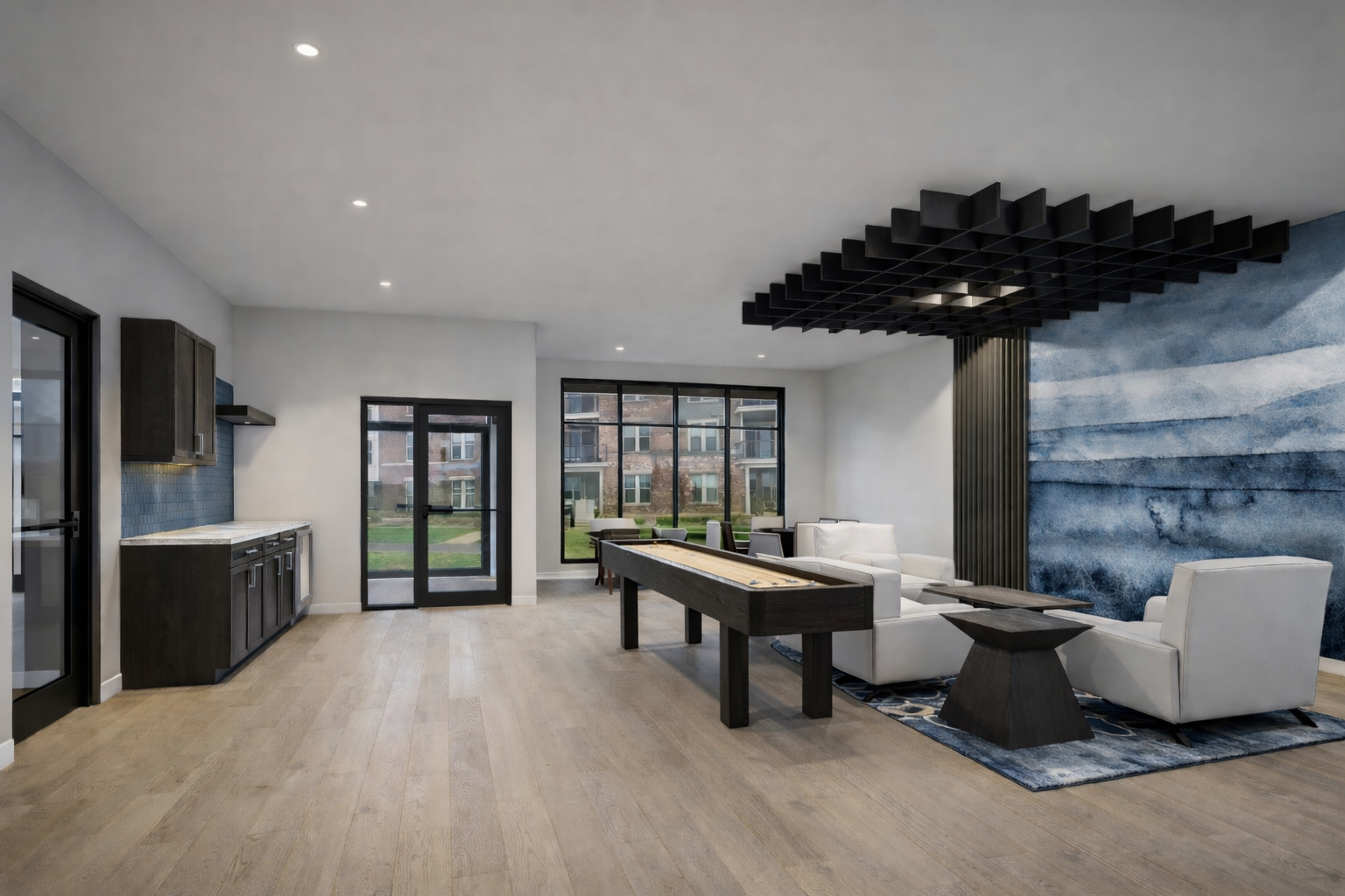 Modern open-plan living room and kitchen with pool table, gray sofa, and large wall mural