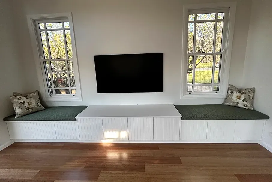 A Wooden Window Seat With TV On Wall — Straight up Building Projects in Belconnen, ACT