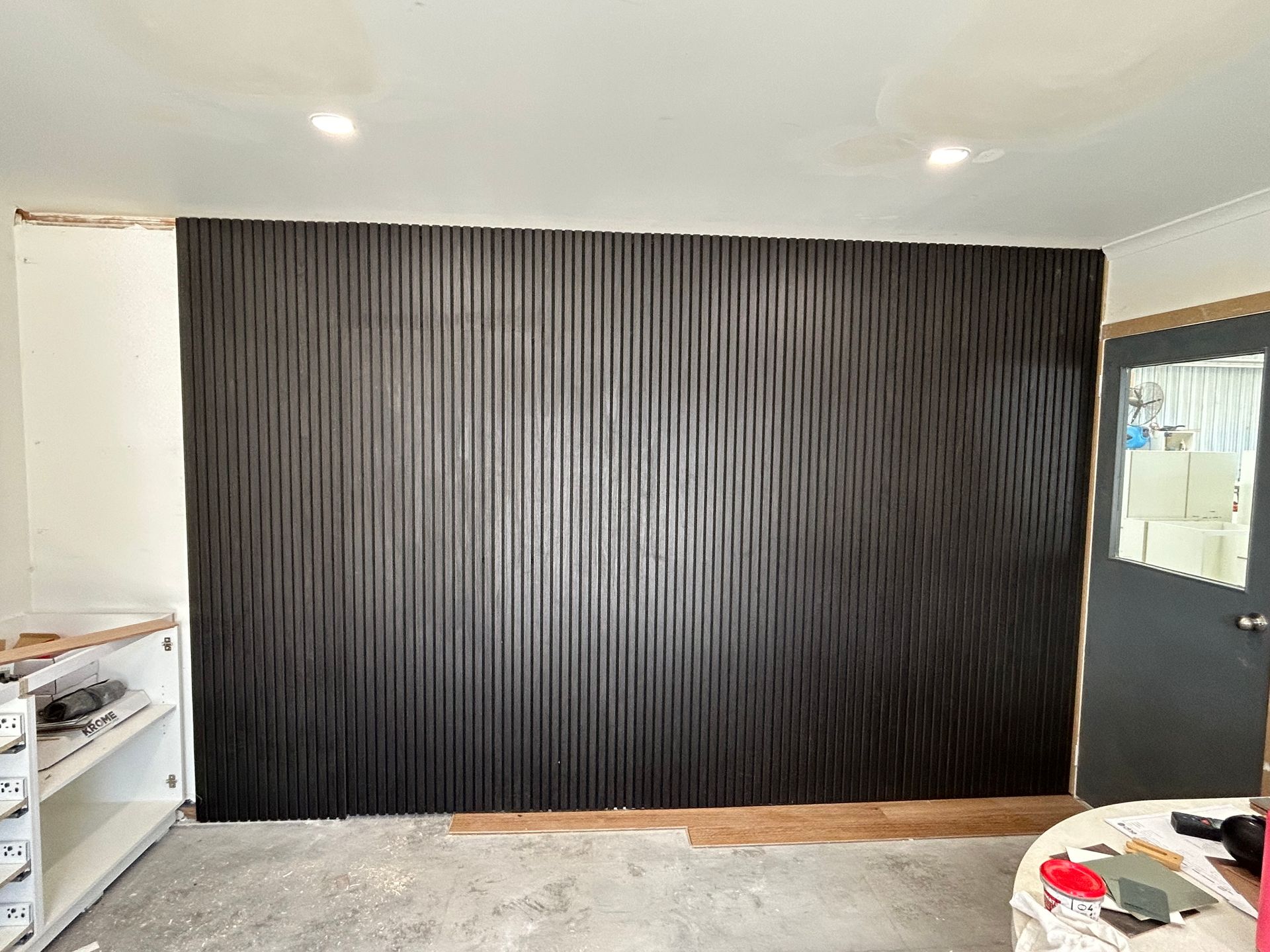 Black vertical slat wall in room under construction. — Straight up Building Projects in Holt, ACT