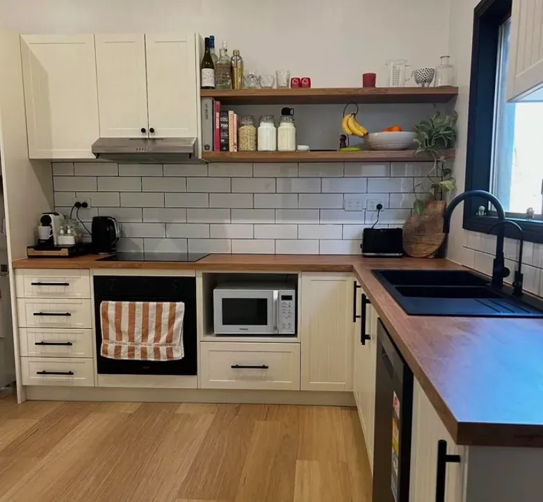 Modern White Kitchen With Wooden Benches And White Tiles — Straight up Building Projects in Holt, ACT