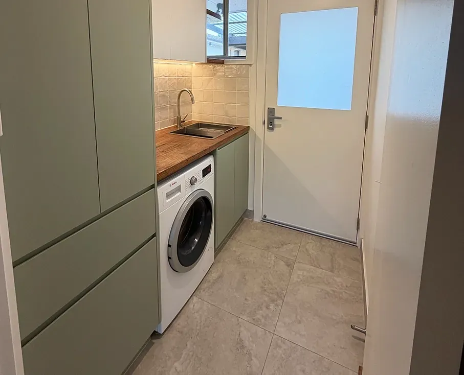A Renovated Laundry With Green Cabinets And Wooden Benchtop — Straight up Building Projects in Ainslie, ACT