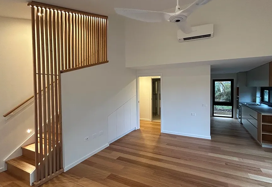 Lounge Room With Wooden Slat Stair Rail — Straight up Building Projects in Holt, ACT